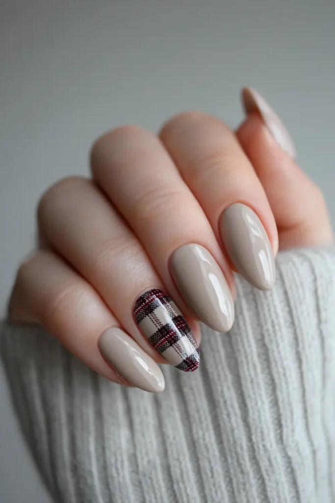 beige almond nails with a plaid accent nail in burgundy and white