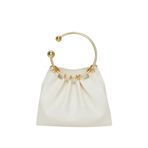 Ivory handbag with sculpted gold ring handle and gathered detailing — elegant sustainable statement bag.