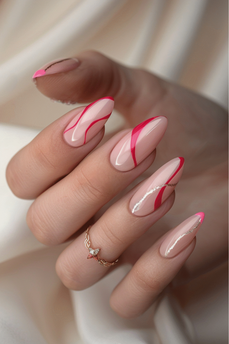 Nude pink Valentine’s nails with modern red swirly lines and subtle shimmer accents