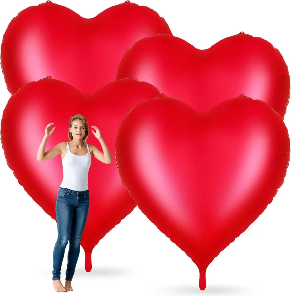 Oversized red heart foil balloons for Valentine’s Day party decor, standing taller than a person on a white background.