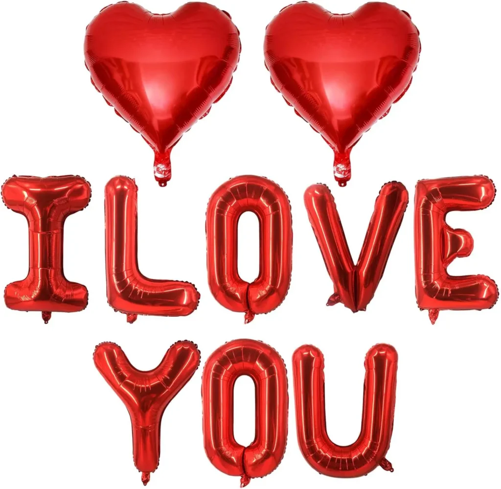 Red foil balloon letters spelling “I LOVE YOU” with heart balloons, Valentine’s Day decoration set on white background.
