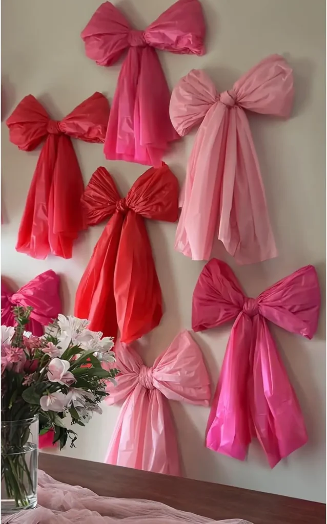 71RDJcZ9RJL._AC_SL1500_ Pink and red tissue paper bows wall decor for Valentine’s Day, romantic DIY backdrop with soft pastel tones.
