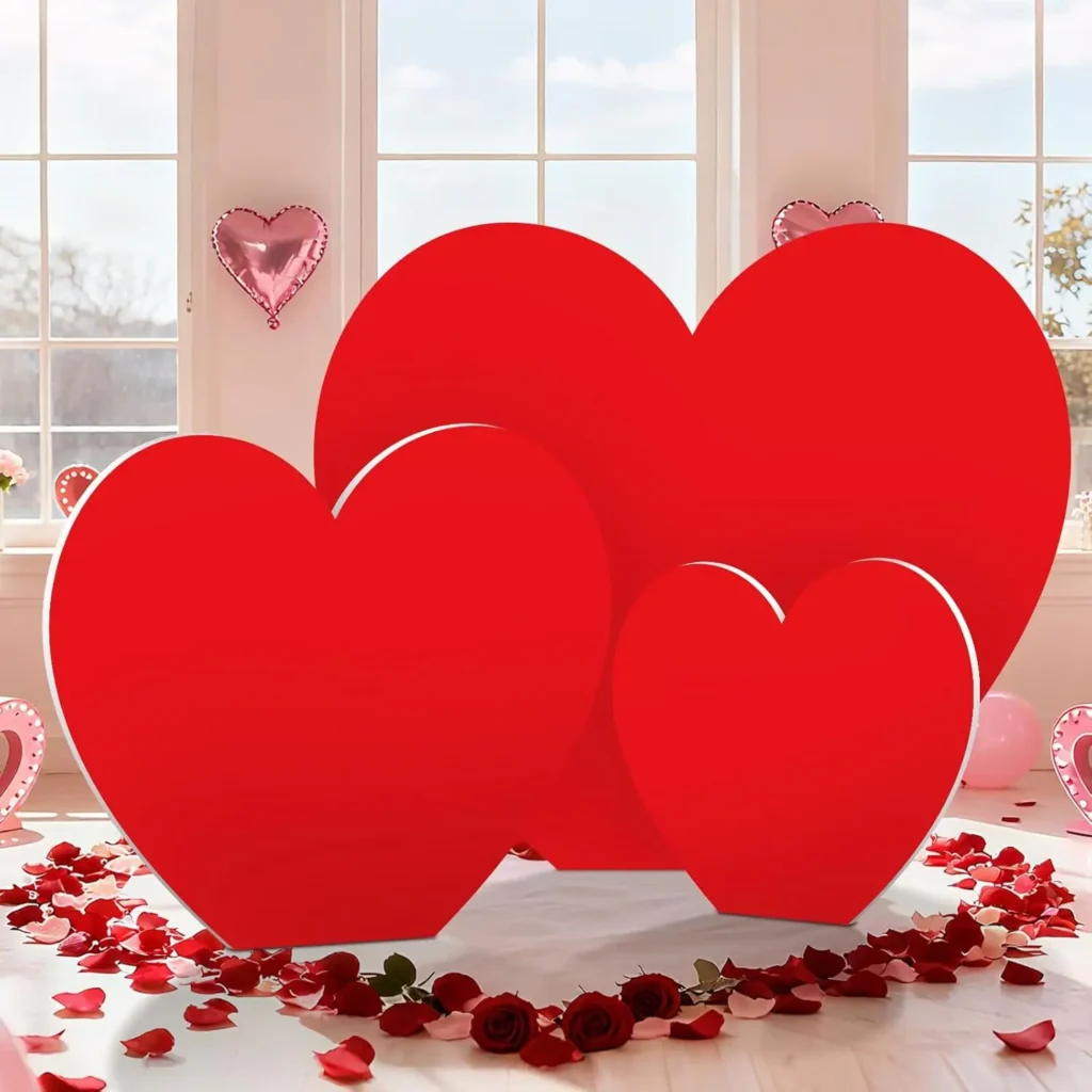 71oZgYiVH8L._AC_SL1500_ Large red heart decorations arranged indoors with rose petals, romantic Valentine’s Day party setup.